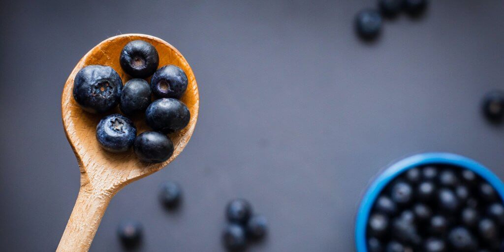 Wooden spoonful of blueberries