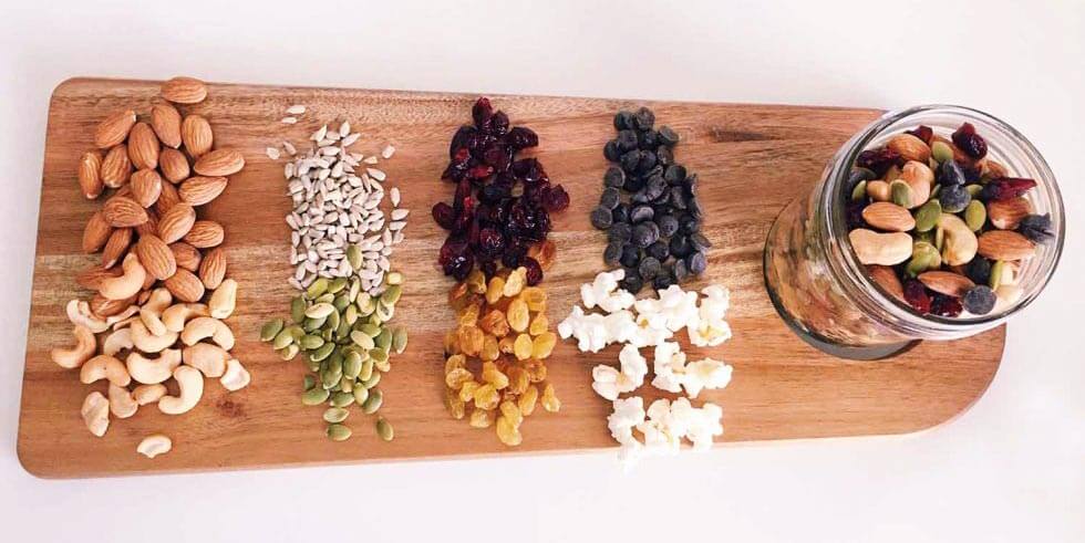 Trail mix ingredients on a wooden cutting board