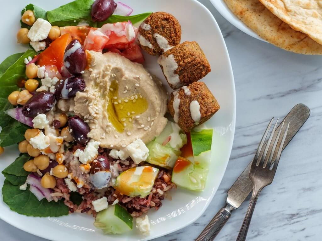 Greek falafel hummus plate with fork and knife