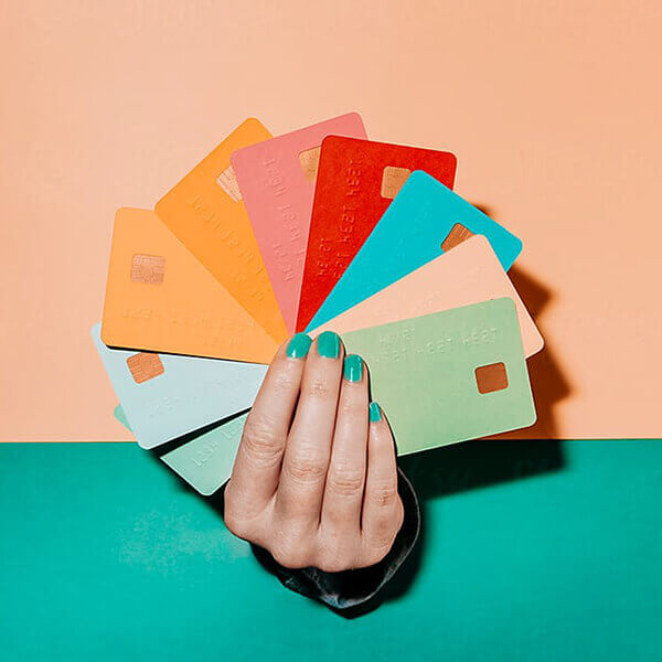 Hand holding colourful debit cards