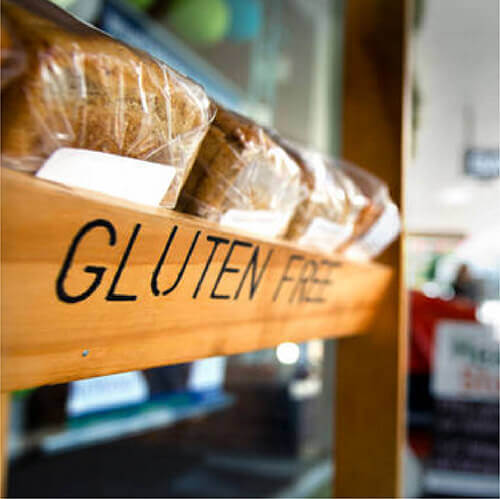 Wooden gluten free sign with loaves of bread
