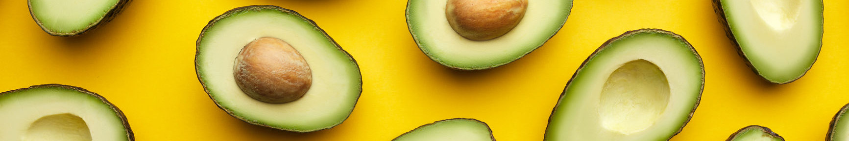 Avocados against a yellow background