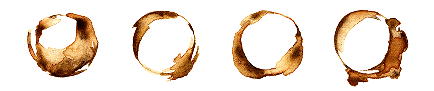 Four coffee mug stains against a white background