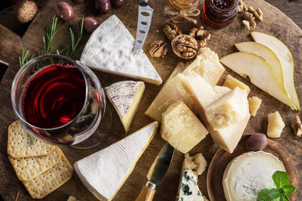 Various cheeses with wine and crackers