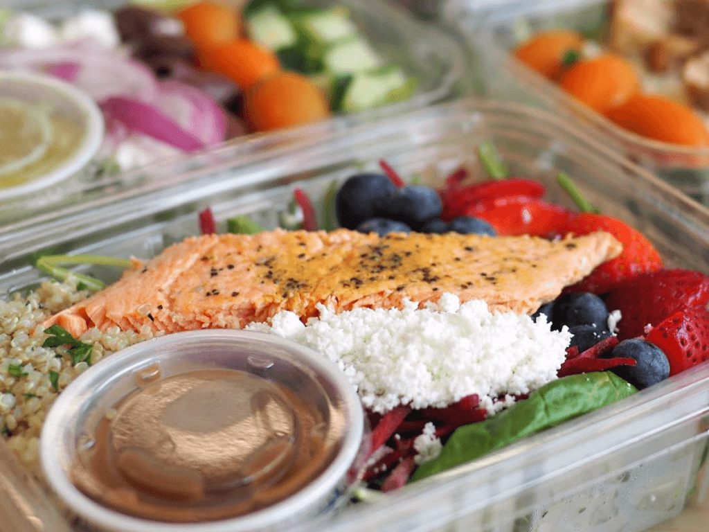 Salmon and berry salad in grab and go containers