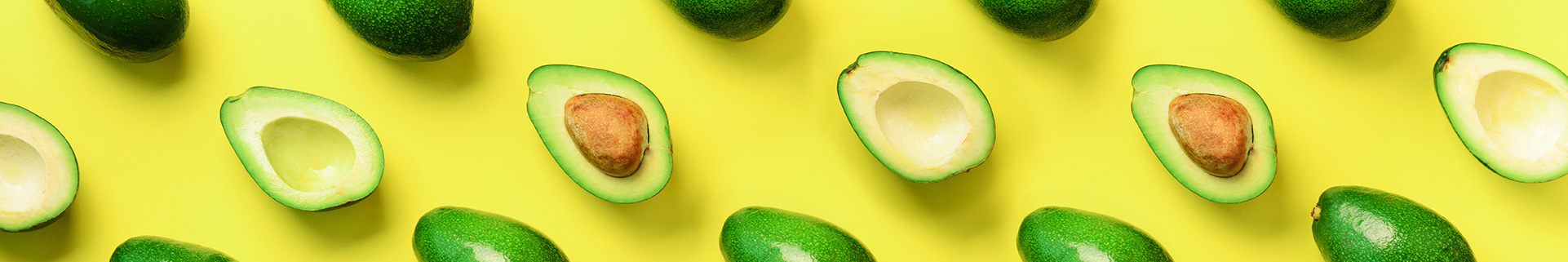 Avocados against a yellow background