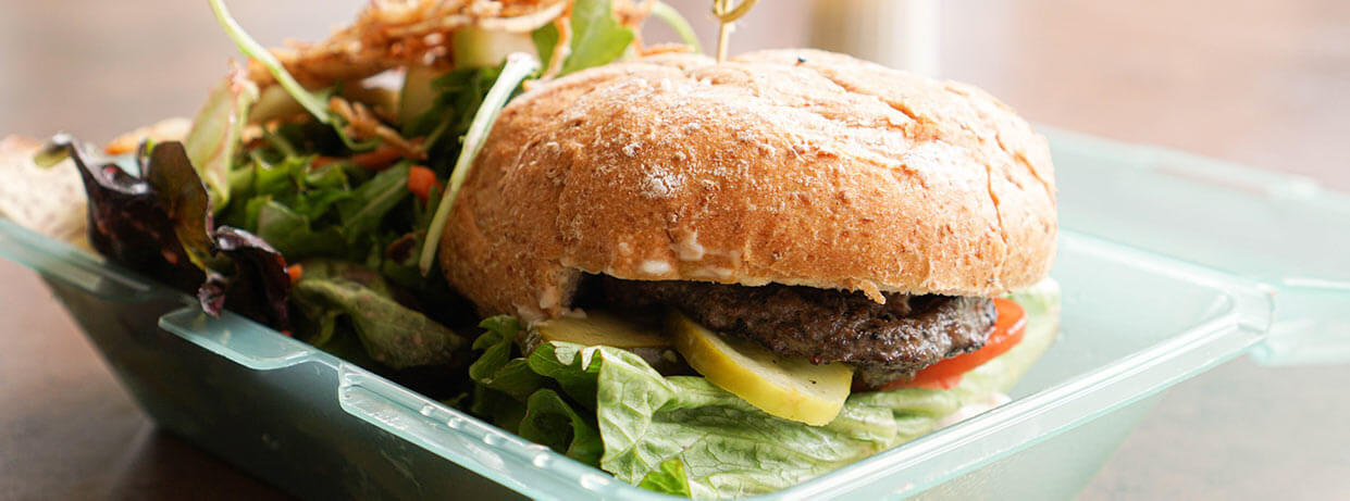 Burger and salad in a Green2Go container