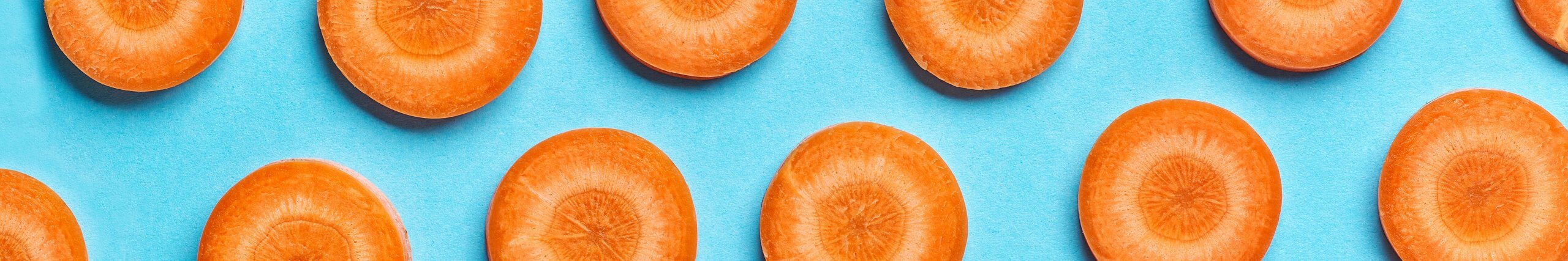 Sliced carrots against a blue background
