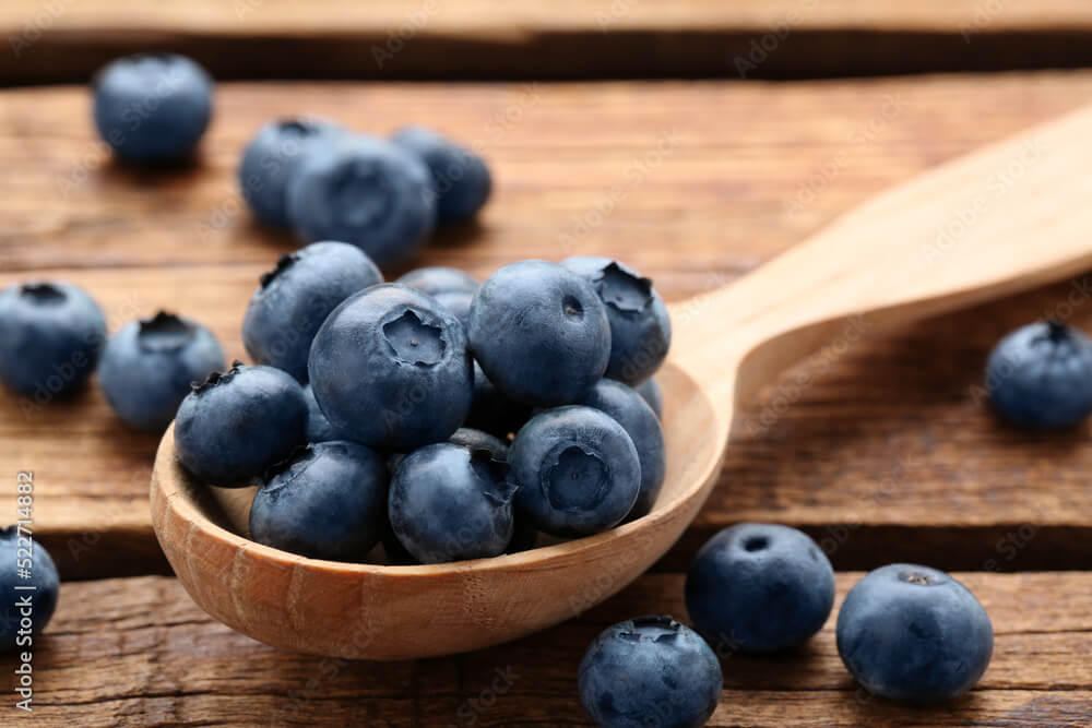 Blueberries in a wooden spoon